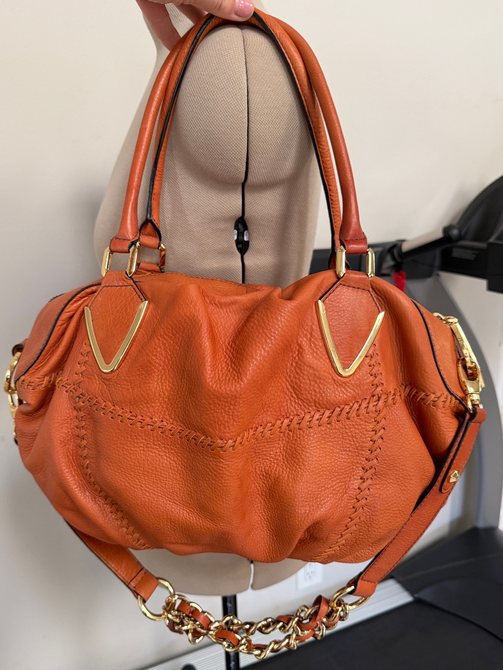 Orange leather handbag appears to be a slouchy style by orYany